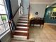 Staircase with wooden steps and white railings adjacent to a sideboard at 130 Harbour Cove Way, Clermont, FL 34711