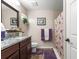 Tastefully designed bathroom with granite countertops, a framed mirror, and a shower with purple accents at 13057 Sw 85Th Cir, Ocala, FL 34473