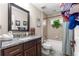 Bathroom showcasing a granite vanity, tiled shower, and a garden window at 13057 Sw 85Th Cir, Ocala, FL 34473