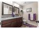 Charming bathroom with granite countertops, dual mirrors, and coordinated purple accents for a stylish touch at 13057 Sw 85Th Cir, Ocala, FL 34473