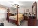 Bedroom featuring a four-poster bed, two dressers and warm, neutral wall colors at 13057 Sw 85Th Cir, Ocala, FL 34473