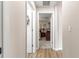 Hallway with wood-look floors, neutral walls, and doorways leading to the bedroom and other rooms at 13057 Sw 85Th Cir, Ocala, FL 34473