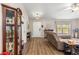 Comfortable living room with neutral walls and wood-look floors, complemented by a cozy leather sofa and stylish furnishings at 13057 Sw 85Th Cir, Ocala, FL 34473