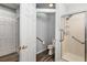 Bathroom with a shower featuring handrails and an enclosed toilet area with handrails and wood look flooring at 13187 Se 93Rd Terrace Rd, Summerfield, FL 34491