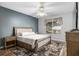 Bedroom featuring wood floors, light walls, natural lighting, and a decorative ceiling fan at 13187 Se 93Rd Terrace Rd, Summerfield, FL 34491