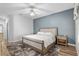 Bedroom featuring wood floors, light walls, natural lighting, and a decorative ceiling fan at 13187 Se 93Rd Terrace Rd, Summerfield, FL 34491