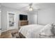 Bedroom featuring wood floors, door to patio, and a wooden dresser at 13187 Se 93Rd Terrace Rd, Summerfield, FL 34491