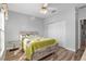 Bedroom with a ceiling fan, hardwood floors, a large window, and an off-white closet door at 13187 Se 93Rd Terrace Rd, Summerfield, FL 34491