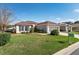 Inviting single-story home with manicured lawn, brown mulch accents, a two-car garage, and a well-maintained facade at 13187 Se 93Rd Terrace Rd, Summerfield, FL 34491