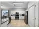 Well-lit kitchen featuring white cabinets and stainless steel appliances at 13187 Se 93Rd Terrace Rd, Summerfield, FL 34491