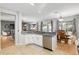 Open concept view of kitchen with breakfast bar, sink, and stainless steel dishwasher at 13187 Se 93Rd Terrace Rd, Summerfield, FL 34491