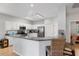 Well-lit kitchen with white cabinets, stainless steel appliances, and a breakfast bar at 13187 Se 93Rd Terrace Rd, Summerfield, FL 34491