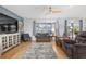 Cozy living room with a blue accent wall, large TV, and a ceiling fan at 13187 Se 93Rd Terrace Rd, Summerfield, FL 34491