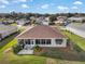 Aerial view of a home showcasing its screened lanai, patio seating, well-maintained backyard, and neighborhood setting at 13187 Se 93Rd Terrace Rd, Summerfield, FL 34491