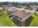 Aerial view of a home showcasing its screened lanai, well-maintained backyard, mature trees, and neighborhood setting at 13187 Se 93Rd Terrace Rd, Summerfield, FL 34491