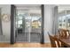 Sunroom with gray drapes, hardwood floors, a ceiling fan, and views of the exterior landscaping at 13187 Se 93Rd Terrace Rd, Summerfield, FL 34491