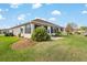 Enclosed sunroom boasts large windows, letting in ample natural light, and a tranquil view of the landscaped backyard at 13187 Se 93Rd Terrace Rd, Summerfield, FL 34491