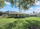 Well-manicured backyard with lush green grass and an inviting view of the home's rear exterior at 14605 Sw 20Th Pl, Ocala, FL 34481