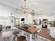 Bright and airy dining area featuring stylish lighting, a large table with seating, and an open floor plan at 14605 Sw 20Th Pl, Ocala, FL 34481