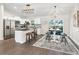 Beautiful kitchen featuring stainless steel appliances, a kitchen island with bar stools, and modern lighting at 14605 Sw 20Th Pl, Ocala, FL 34481