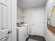 The laundry room has a washer and dryer with a wire shelf above at 14605 Sw 20Th Pl, Ocala, FL 34481