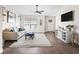 Inviting living room featuring wood floors, a comfortable sofa, a TV, and a stylish area rug at 14605 Sw 20Th Pl, Ocala, FL 34481