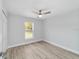 A standard bedroom with gray wood-look floors and a ceiling fan at 15123 Se 63Rd Ct, Summerfield, FL 34491