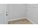 A modern laundry room with gray wood-look flooring and white trim at 15123 Se 63Rd Ct, Summerfield, FL 34491