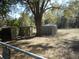 Backyard with three storage sheds and a large tree providing plenty of shade at 18800 Sw 31St St, Dunnellon, FL 34432