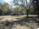 Large backyard with a mix of open space and natural tree coverage; great for privacy and outdoor activities at 18800 Sw 31St St, Dunnellon, FL 34432