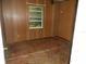 Bedroom with wood paneling walls, and a window that offers natural light at 18800 Sw 31St St, Dunnellon, FL 34432
