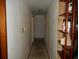 Hallway with a shelf on the right, providing access to multiple rooms at 18800 Sw 31St St, Dunnellon, FL 34432