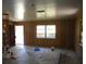 Spacious living room featuring wood paneling, and a large window at 18800 Sw 31St St, Dunnellon, FL 34432