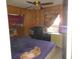 Bedroom with a bed, dresser, window, and fan at 18800 Sw 31St St, Dunnellon, FL 34432