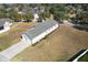 Aerial view of the backyard featuring covered porch, exterior door, and grass at 2032 Se 27Th Rd, Ocala, FL 34471