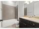 Bathroom featuring a single vanity and shower-tub combo with modern tile at 2032 Se 27Th Rd, Ocala, FL 34471