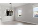 Open dining area with pendant lighting and a view of the adjacent kitchen, bathed in natural light from the windows at 2032 Se 27Th Rd, Ocala, FL 34471