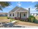 Charming home with a welcoming front porch, brick accents and a well-manicured lawn at 2032 Se 27Th Rd, Ocala, FL 34471