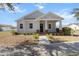 Charming single-story home featuring a welcoming front porch with red brick pillars and a well-manicured lawn at 2032 Se 27Th Rd, Ocala, FL 34471