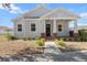 Charming single-story home featuring a welcoming front porch with red brick pillars and a well-manicured lawn at 2032 Se 27Th Rd, Ocala, FL 34471