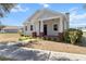 Charming single-story home featuring a welcoming front porch with red brick pillars and a well-manicured lawn at 2032 Se 27Th Rd, Ocala, FL 34471