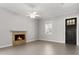 Bright living room featuring a stone fireplace, ceiling fan, and a dark-stained front door at 2032 Se 27Th Rd, Ocala, FL 34471