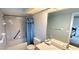 Neutral bathroom featuring a shower-tub combo, light blue walls, and a white sink at 21353 Sw Beach Blvd, Dunnellon, FL 34431