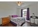 Bedroom featuring a bed with purple accents, hardwood floors, and natural light at 2209 Nw 55Th Avenue Rd, Ocala, FL 34482