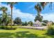 Scenic clubhouse view showcasing manicured lawns, mature trees, and classic architecture under a bright blue sky at 2209 Nw 55Th Avenue Rd, Ocala, FL 34482