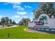 Ocala Palms Golf Community sign with lush landscaping and clear blue skies at 2209 Nw 55Th Avenue Rd, Ocala, FL 34482