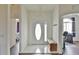 Bright foyer with white door and trim, tile flooring, and bench seating at 2209 Nw 55Th Avenue Rd, Ocala, FL 34482