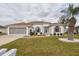 Charming home featuring a well-manicured lawn, two-car garage and attractive landscaping at 2209 Nw 55Th Avenue Rd, Ocala, FL 34482