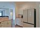 Kitchen with stainless steel refrigerator and a view into the cozy living space at 2209 Nw 55Th Avenue Rd, Ocala, FL 34482