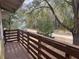 Wood porch with a view of the surrounding trees and yard at 2851 Ne 162Nd Ln, Citra, FL 32113